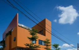 Ngôi nhà màu cam nổi bật trên nền cây xanh